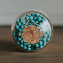 Load image into Gallery viewer, tiny jar of turquoise matches with striker on bottom
