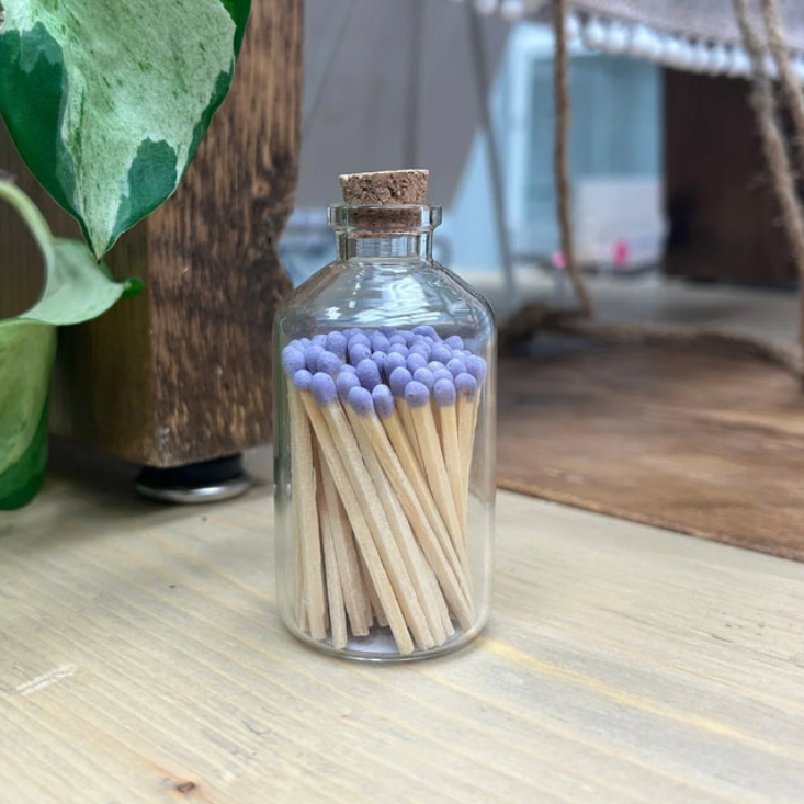 tiny jar of purple matches with striker on bottom