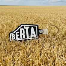 Load image into Gallery viewer, Keychain with 'BERTA' branding on a textured gray background
