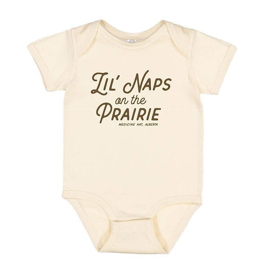Beige baby onesie with 'Lil' Naps on the Prairie' text on a white background