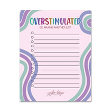 Load image into Gallery viewer, A pastel notepad with the text 'OVERSTIMULATED SO, MAKING ANOTHER LIST' at the top, lined writing space in the center, and abstract wavy border patterns in pink, purple, and mint green. The brand name 'sybee design' appears at the bottom.
