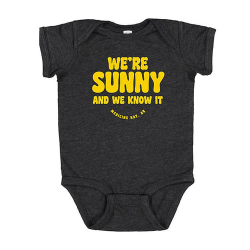 Black baby onesie with yellow text that says we're sunny and we know it medicine hat alberta